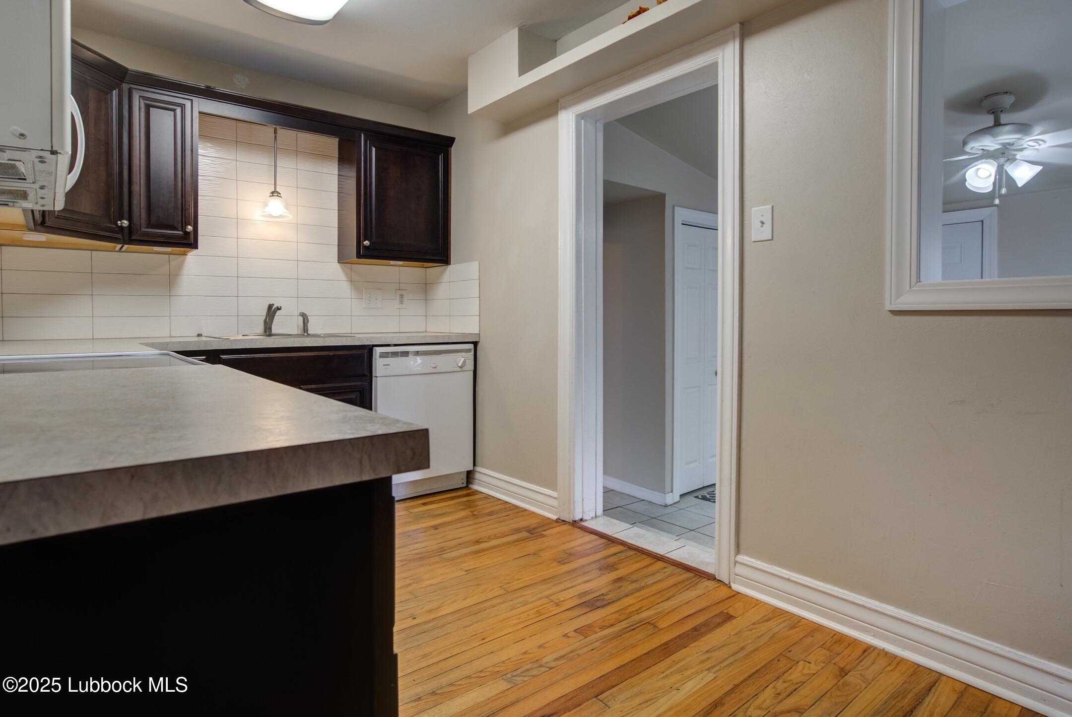 2308 28th Street Lubbock, TX 79411 - Photo 5 of 21 a kitchen with stainless steel appliances granite countertop a sink and a stove top oven