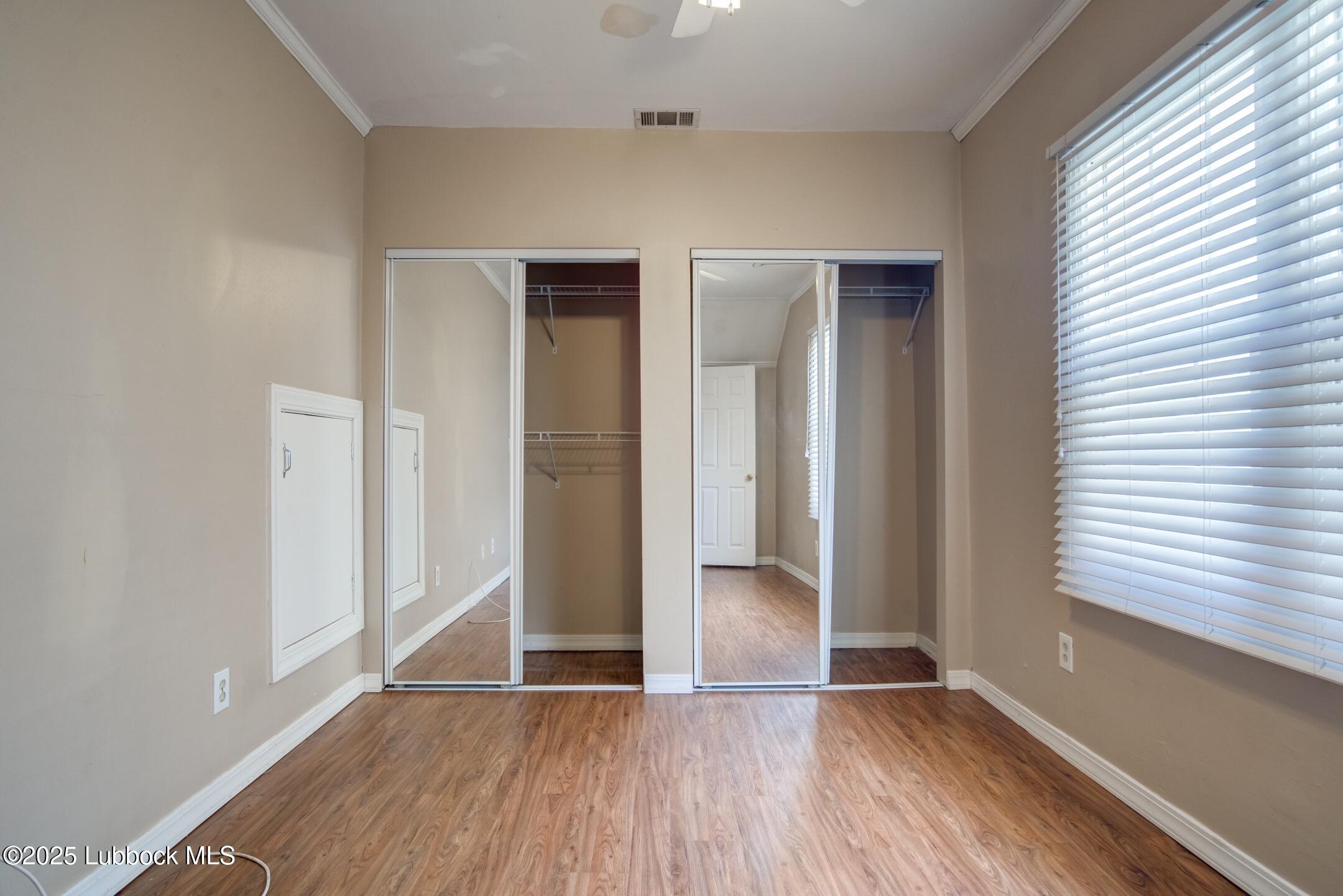 2308 28th Street Lubbock, TX 79411 - Photo 9 of 21 an empty room with wooden floor and windows