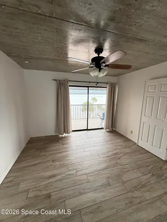 a view of wooden floor and windows in a room