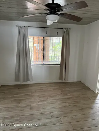 a view of a terrace with lawn chairs