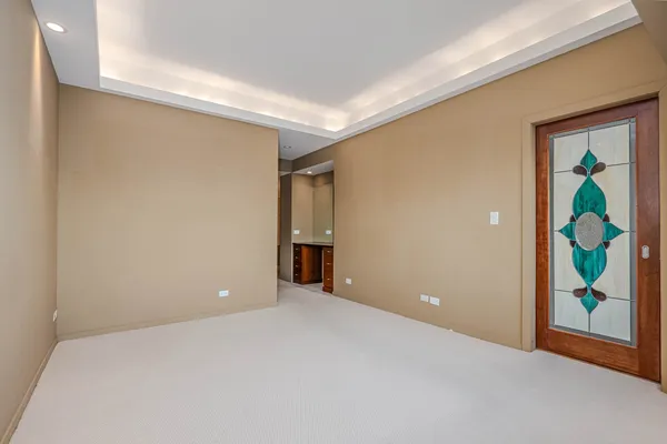 a view of an empty room with painting on the wall