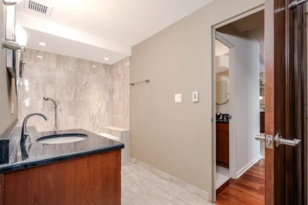 a bathroom with a sink a mirror and a shower