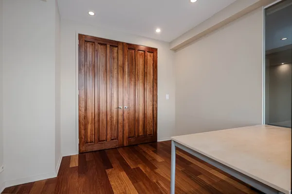 a view of a room with wooden floor