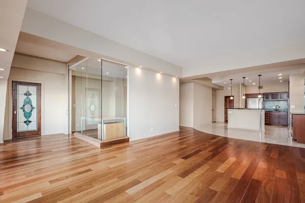a view of a room with wooden floor