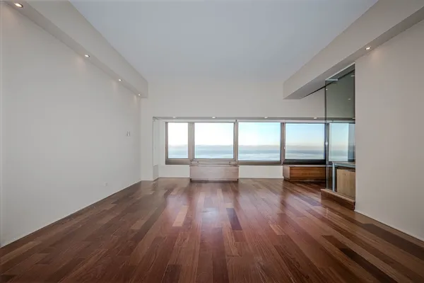 a view of room with hardwood flooring and ceiling fan
