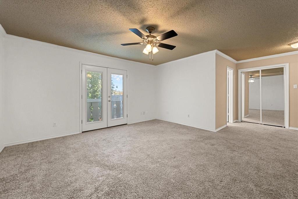2312 Perkins Road Arlington, TX 76016 - Photo 14 of 29 Spacious bedroom featuring neutral carpeting, a ceiling fan with integrated lighting, and white walls