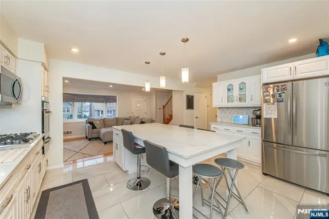 a large kitchen with a table and chairs