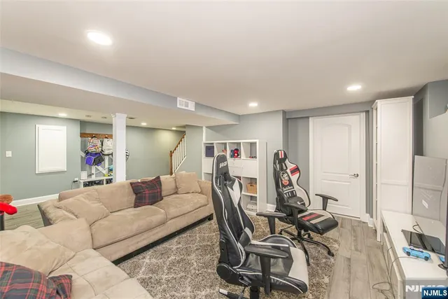 a living room with furniture a desk and chair