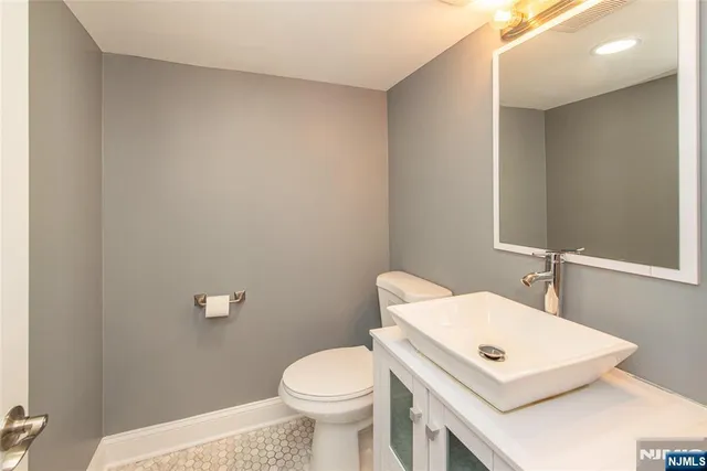 a white toilet sitting next to a bathroom sink