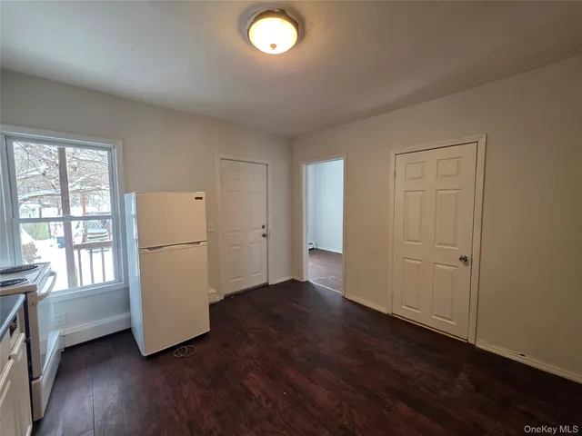 a view of a room with wooden floor and cabinet