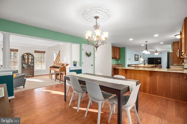 a view of a kitchen with kitchen island a counter top space a sink and cabinets