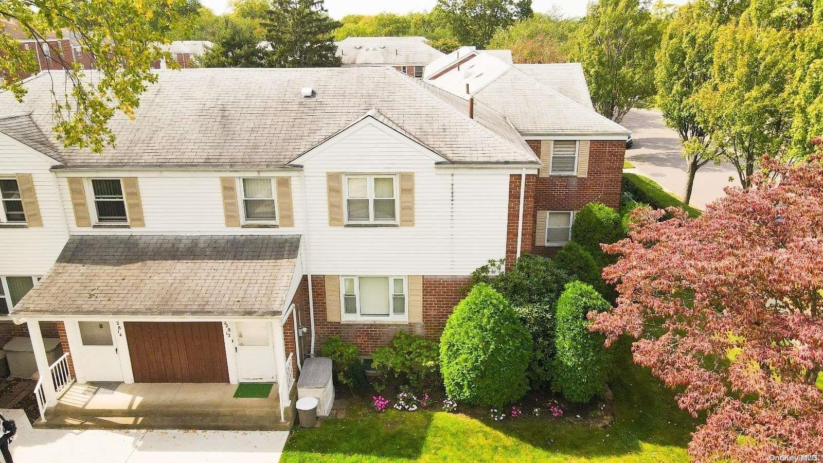 228-12 67th Avenue, Unit 30 Queens, NY 11364 - Photo 1 of 1 front view of a house with a yard