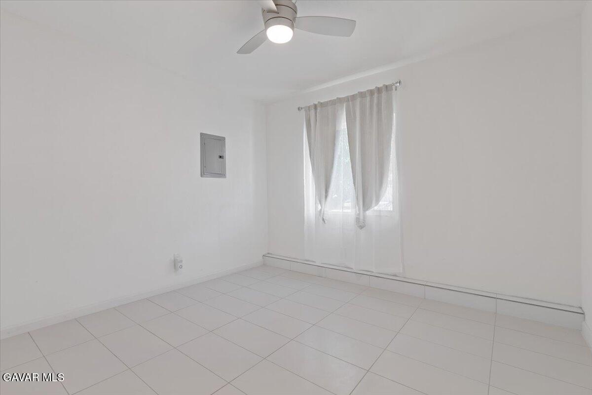 4706 Spice Street, Unit 2 Lancaster, CA 93536 - Photo 11 of 14 an empty room with windows and fan