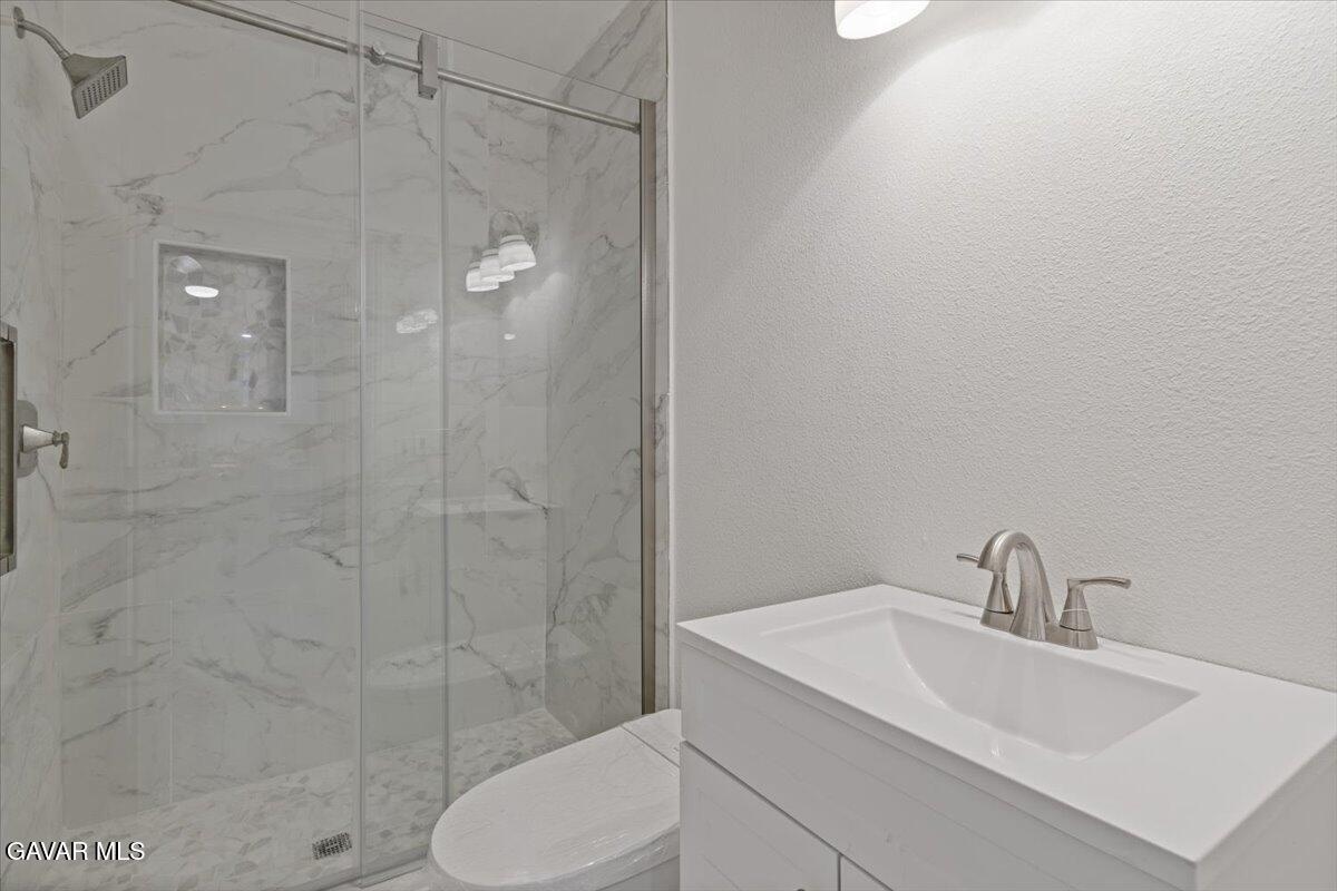 4706 Spice Street, Unit 2 Lancaster, CA 93536 - Photo 3 of 14 a bathroom with a sink toilet and shower