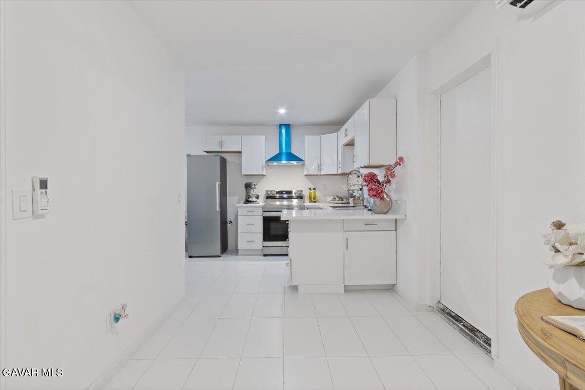 4706 Spice Street, Unit 2 Lancaster, CA 93536 - Photo 5 of 14 a kitchen with white cabinets and white appliances