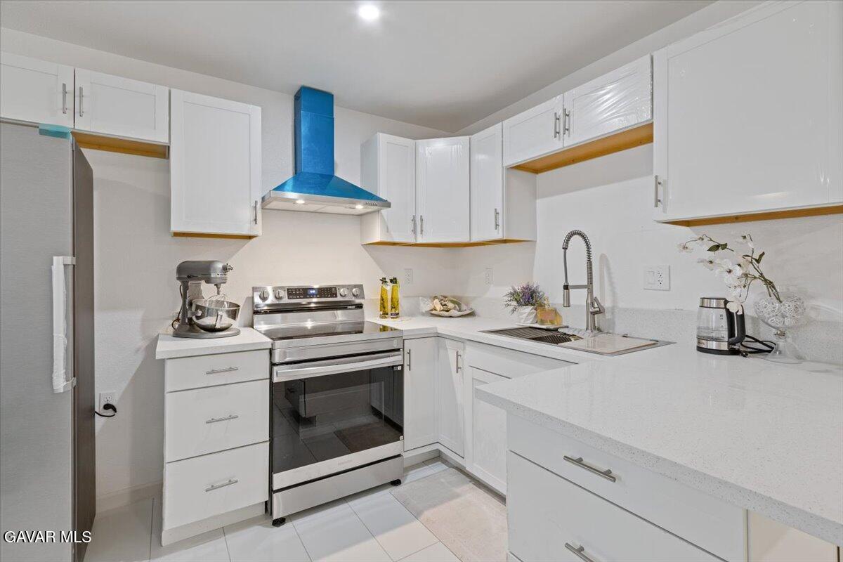 4706 Spice Street, Unit 2 Lancaster, CA 93536 - Photo 6 of 14 a kitchen with stainless steel appliances granite countertop a sink and a stove