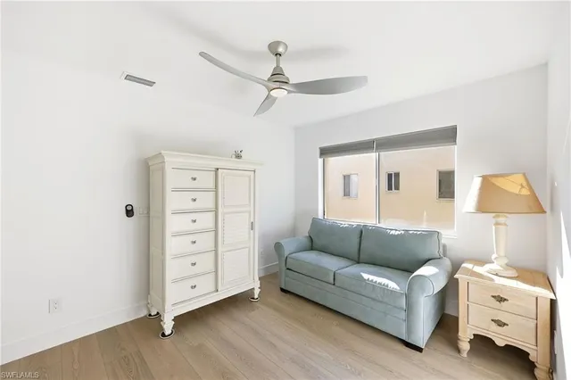 a kitchen with stainless steel appliances granite countertop a stove a refrigerator and a dining table with wooden floor