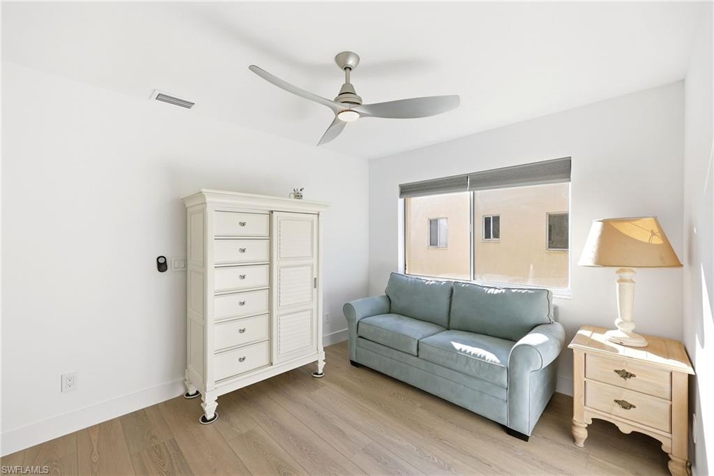 7707 Jewel Lane, Unit 201 Naples, FL 34109 - Photo 11 of 31 Living area with wood finished floors and a ceiling fan