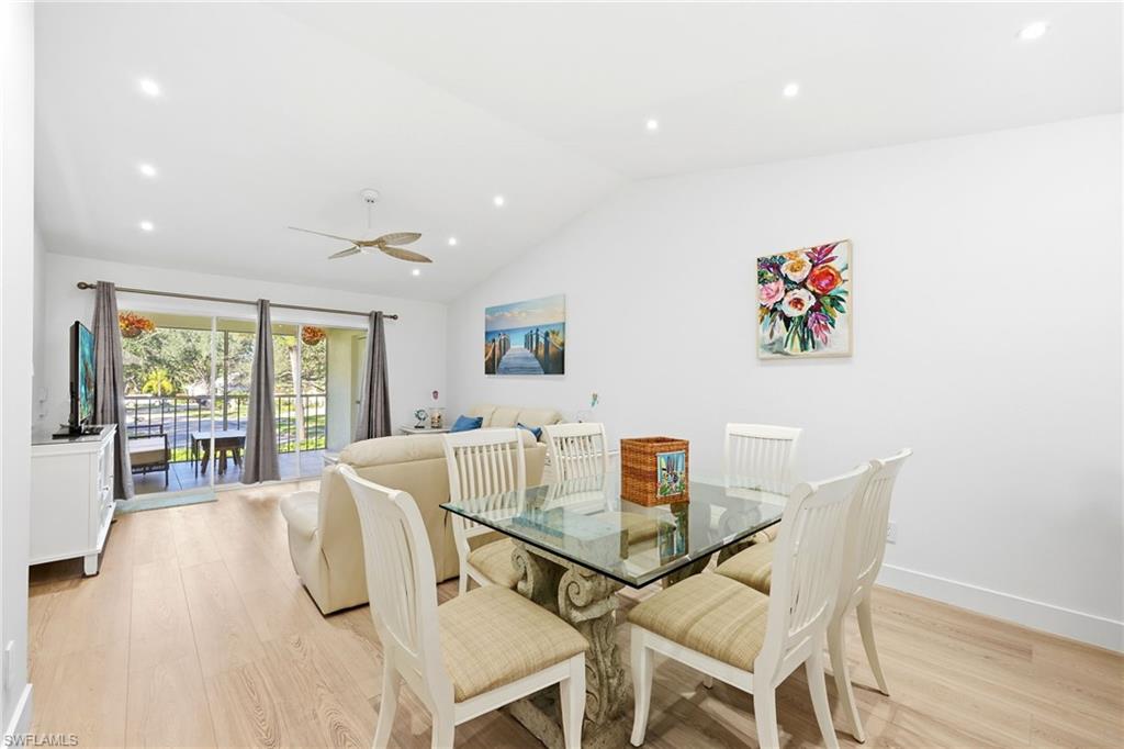 7707 Jewel Lane, Unit 201 Naples, FL 34109 - Photo 12 of 31 Dining room featuring light wood-style floors, recessed lighting, vaulted ceiling, and a ceiling fan