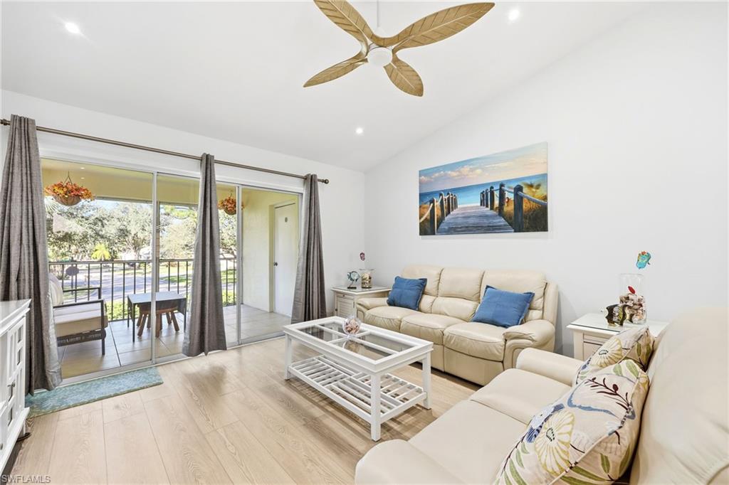 7707 Jewel Lane, Unit 201 Naples, FL 34109 - Photo 14 of 31 Living room featuring light wood-style flooring, vaulted ceiling, ceiling fan, and recessed lighting