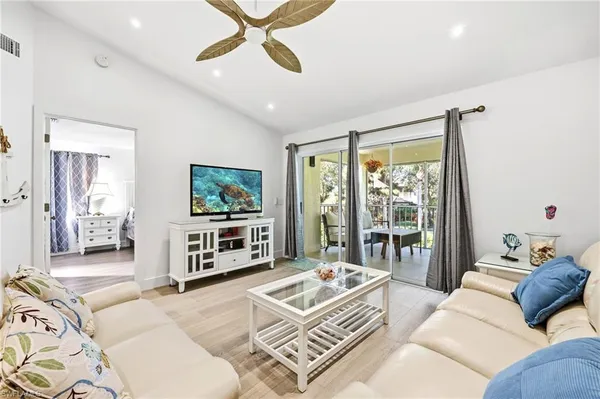 a living room with furniture and a floor to ceiling window