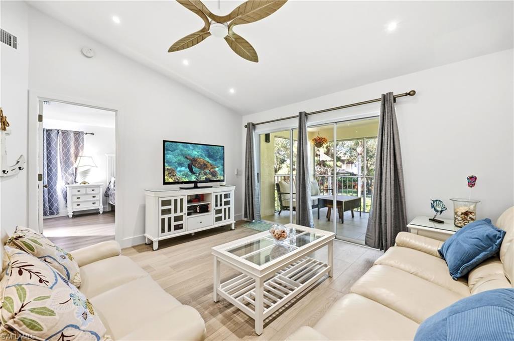 7707 Jewel Lane, Unit 201 Naples, FL 34109 - Photo 15 of 31 Living room featuring recessed lighting, ceiling fan, light wood-style flooring, and high vaulted ceiling