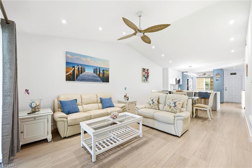 7707 Jewel Lane, Unit 201 Naples, FL 34109 - Photo 16 of 31 Living room featuring light wood-style floors, lofted ceiling, recessed lighting, and a ceiling fan