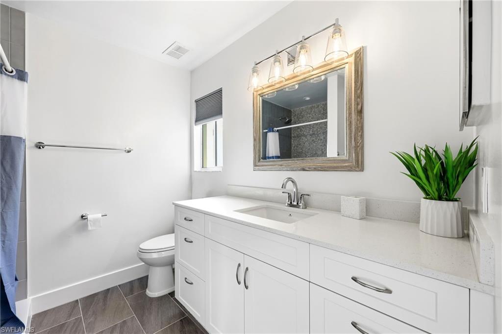 7707 Jewel Lane, Unit 201 Naples, FL 34109 - Photo 25 of 31 Full bath with a shower with shower curtain and vanity