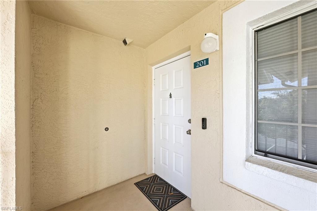 7707 Jewel Lane, Unit 201 Naples, FL 34109 - Photo 3 of 31 Entrance to property featuring stucco siding