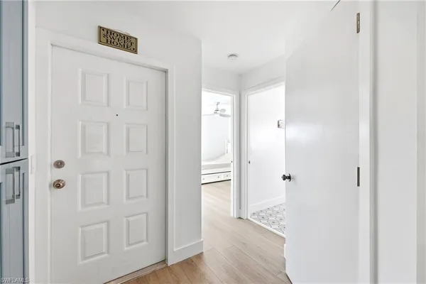 a view of a hallway with wooden floor