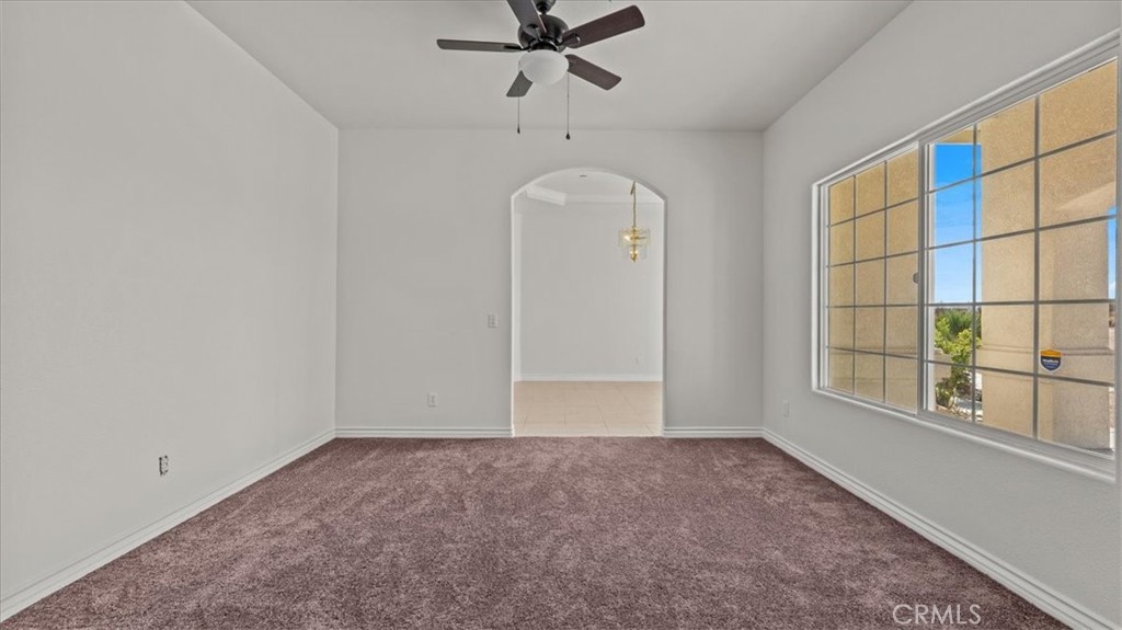 7536 Sunset Road Phelan, CA 92371 - Photo 12 of 40 an empty room with windows and fan