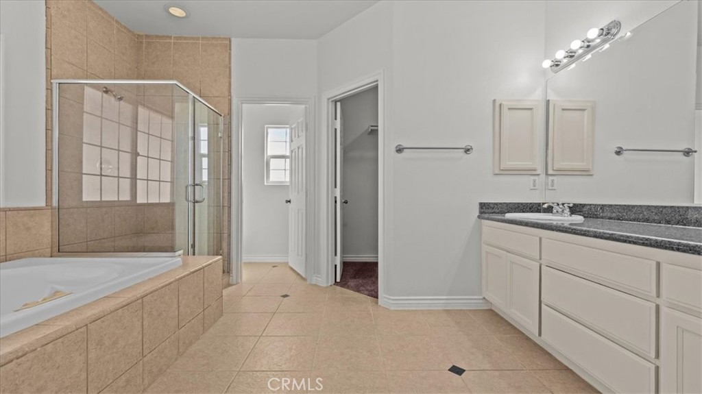 7536 Sunset Road Phelan, CA 92371 - Photo 18 of 40 a bathroom with a granite countertop sink a mirror and a bathtub