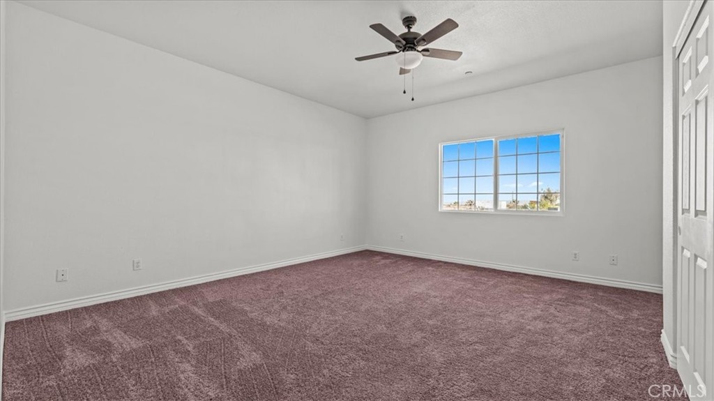 7536 Sunset Road Phelan, CA 92371 - Photo 22 of 40 an empty room with a empty space and windows