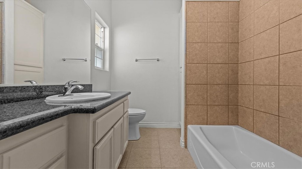 7536 Sunset Road Phelan, CA 92371 - Photo 24 of 40 a bathroom with a granite countertop sink toilet and shower