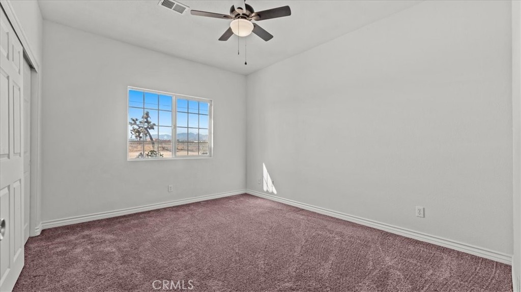 7536 Sunset Road Phelan, CA 92371 - Photo 26 of 40 an empty room with a window and a fan