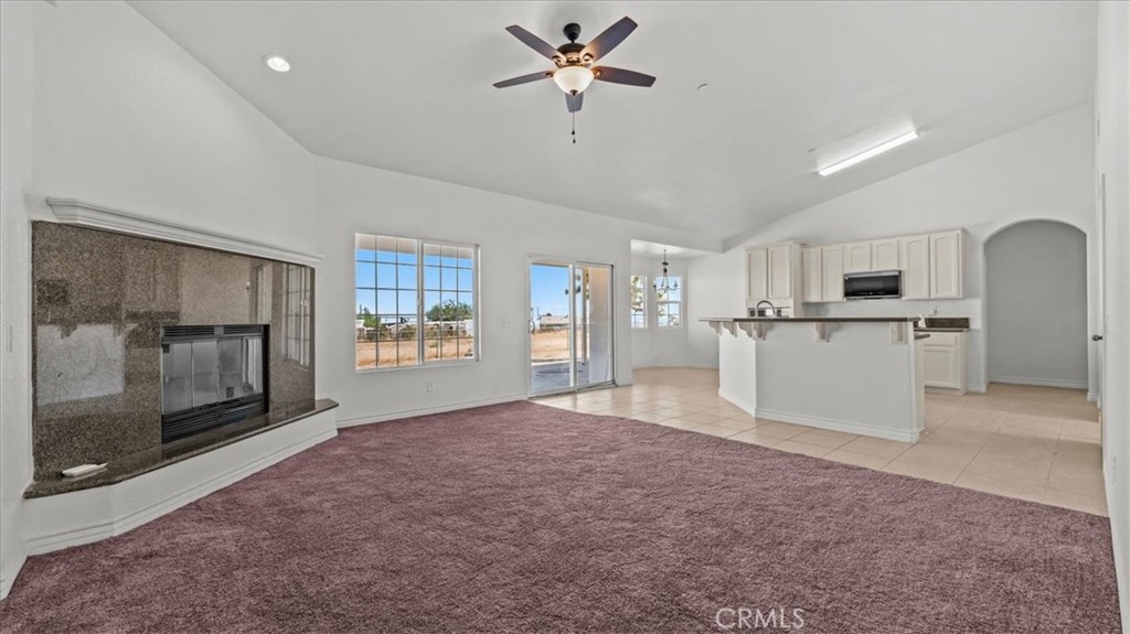 7536 Sunset Road Phelan, CA 92371 - Photo 4 of 40 a view of a kitchen with a stove cabinets a ceiling fan and a wooden floor