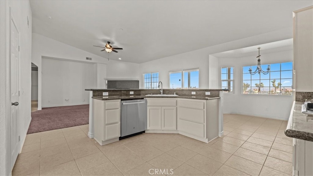 7536 Sunset Road Phelan, CA 92371 - Photo 10 of 40 a kitchen with white cabinets and white appliances