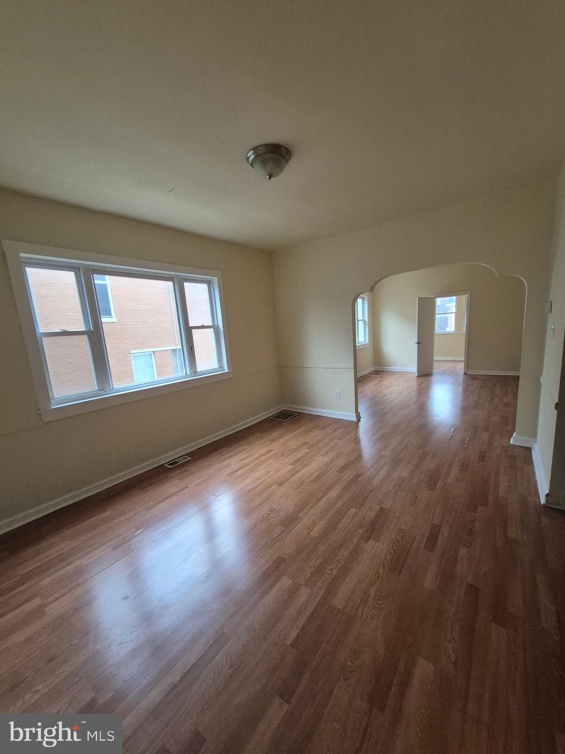 1245 Empire Avenue, Unit 1 Camden, NJ 08103 - Photo 2 of 7 a view of empty room with wooden floor and fan