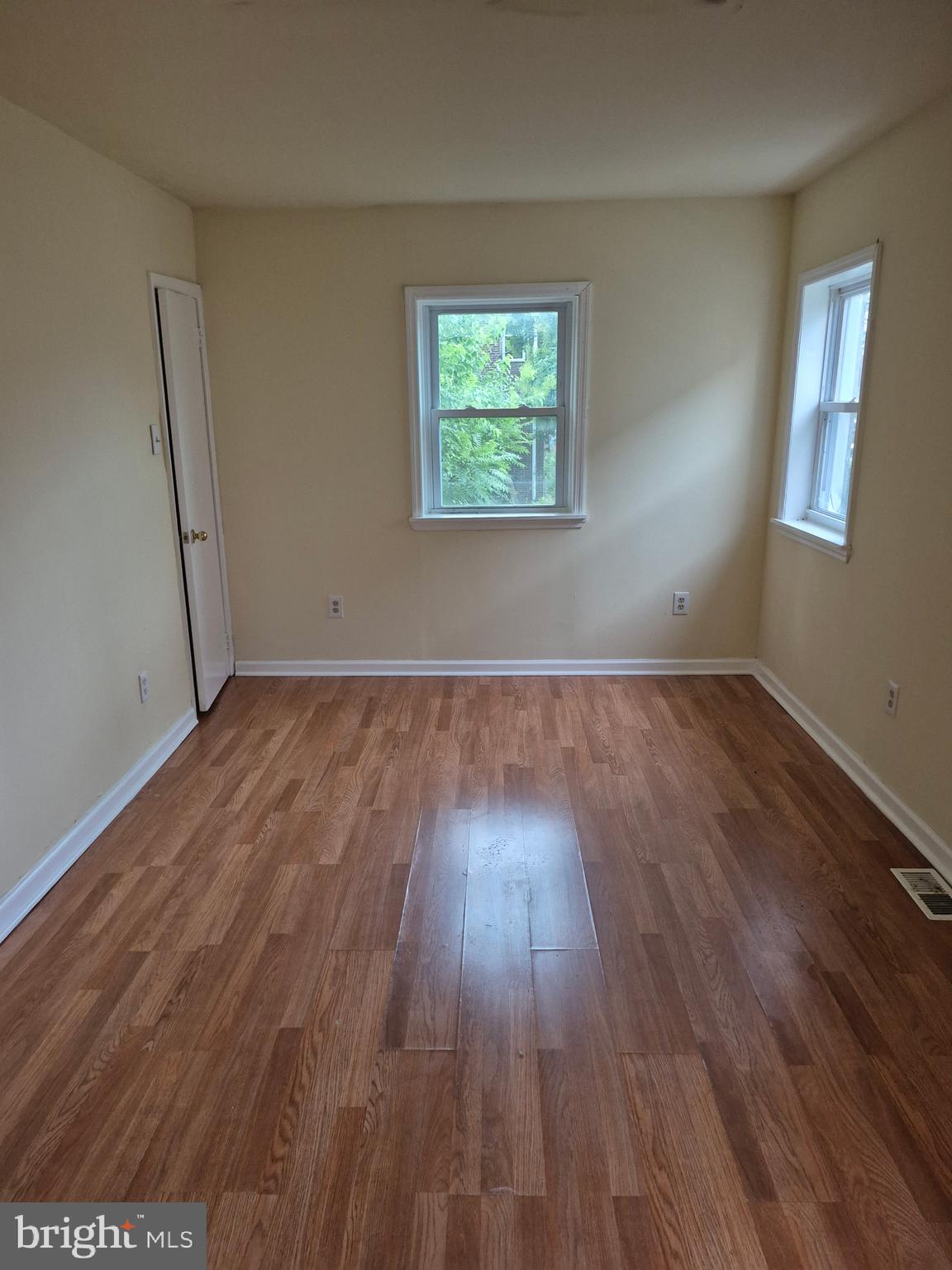1245 Empire Avenue, Unit 1 Camden, NJ 08103 - Photo 6 of 7 an empty room with wooden floor and windows