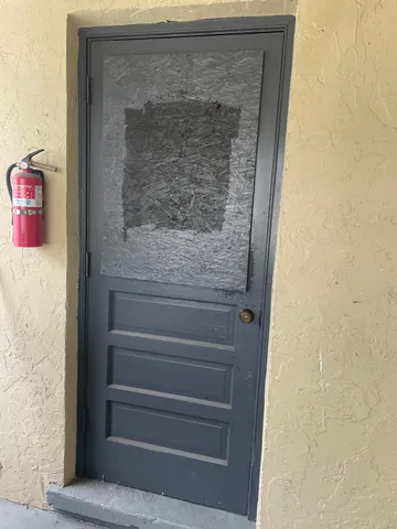 a balcony with a bench and potted plants