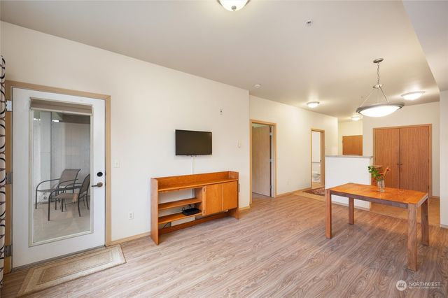 a living room with furniture and a table with wooden floor