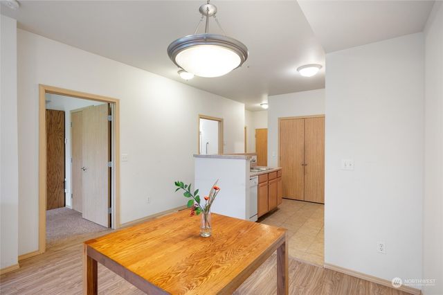 a room with dining table and wooden floor