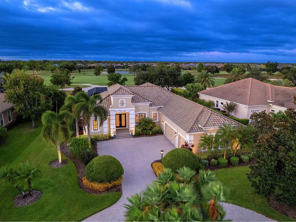 an aerial view of a house with a yard