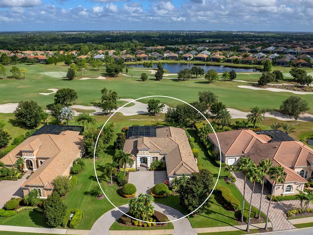 15207 Camargo Place Lakewood Ranch, FL 34202 - Photo 12 of 96 an aerial view of a house with a garden and lake view