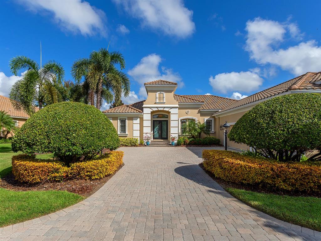 15207 Camargo Place Lakewood Ranch, FL 34202 - Photo 16 of 96 a front view of a house with a yard