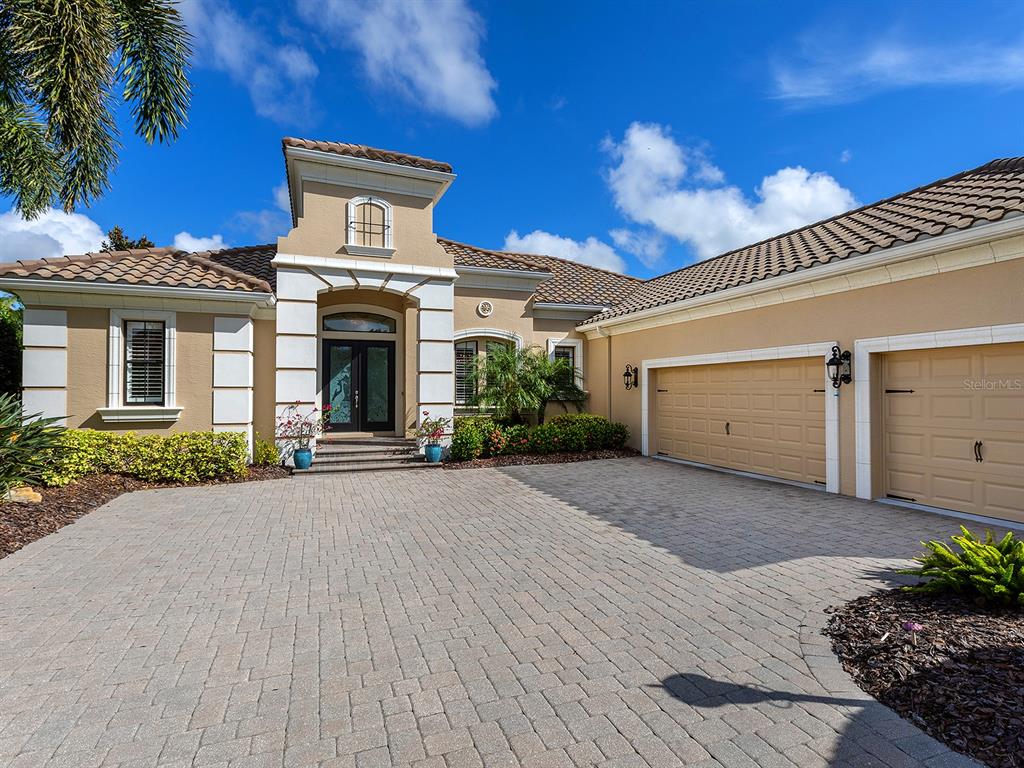 15207 Camargo Place Lakewood Ranch, FL 34202 - Photo 17 of 96 a front view of a house with a yard and garage