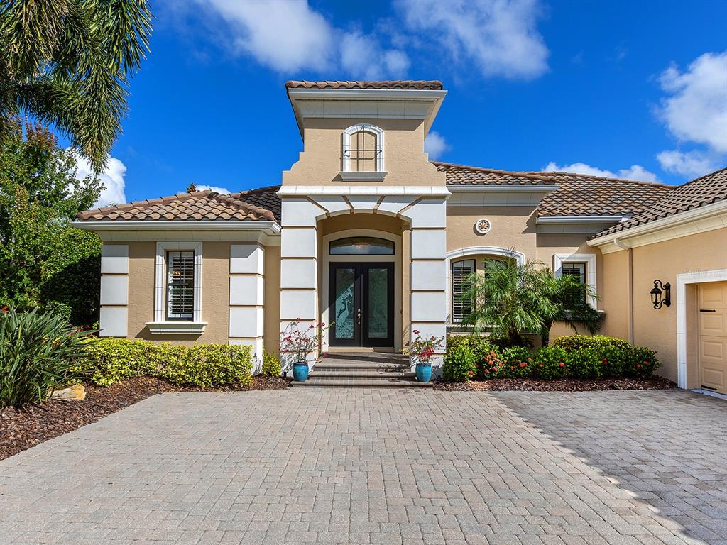 15207 Camargo Place Lakewood Ranch, FL 34202 - Photo 18 of 96 front view of a house with a potted plants