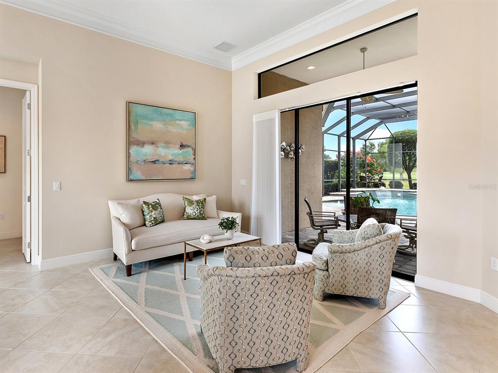15207 Camargo Place Lakewood Ranch, FL 34202 - Photo 20 of 96 a living room with furniture and a large window