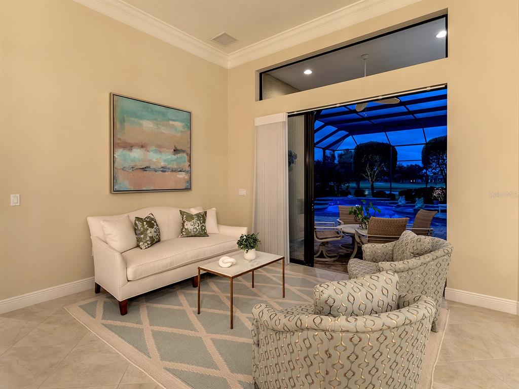 15207 Camargo Place Lakewood Ranch, FL 34202 - Photo 23 of 96 a living room with furniture and a ceiling fan