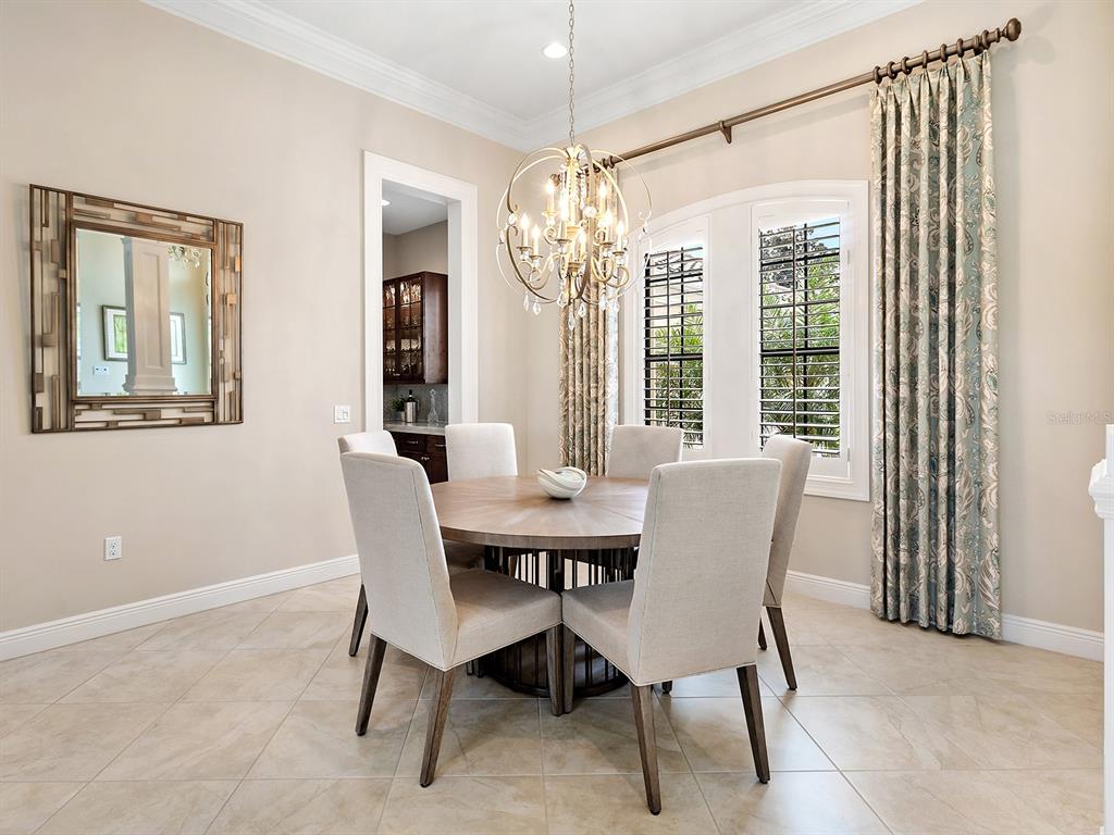 15207 Camargo Place Lakewood Ranch, FL 34202 - Photo 26 of 96 a view of a dining room with furniture and window